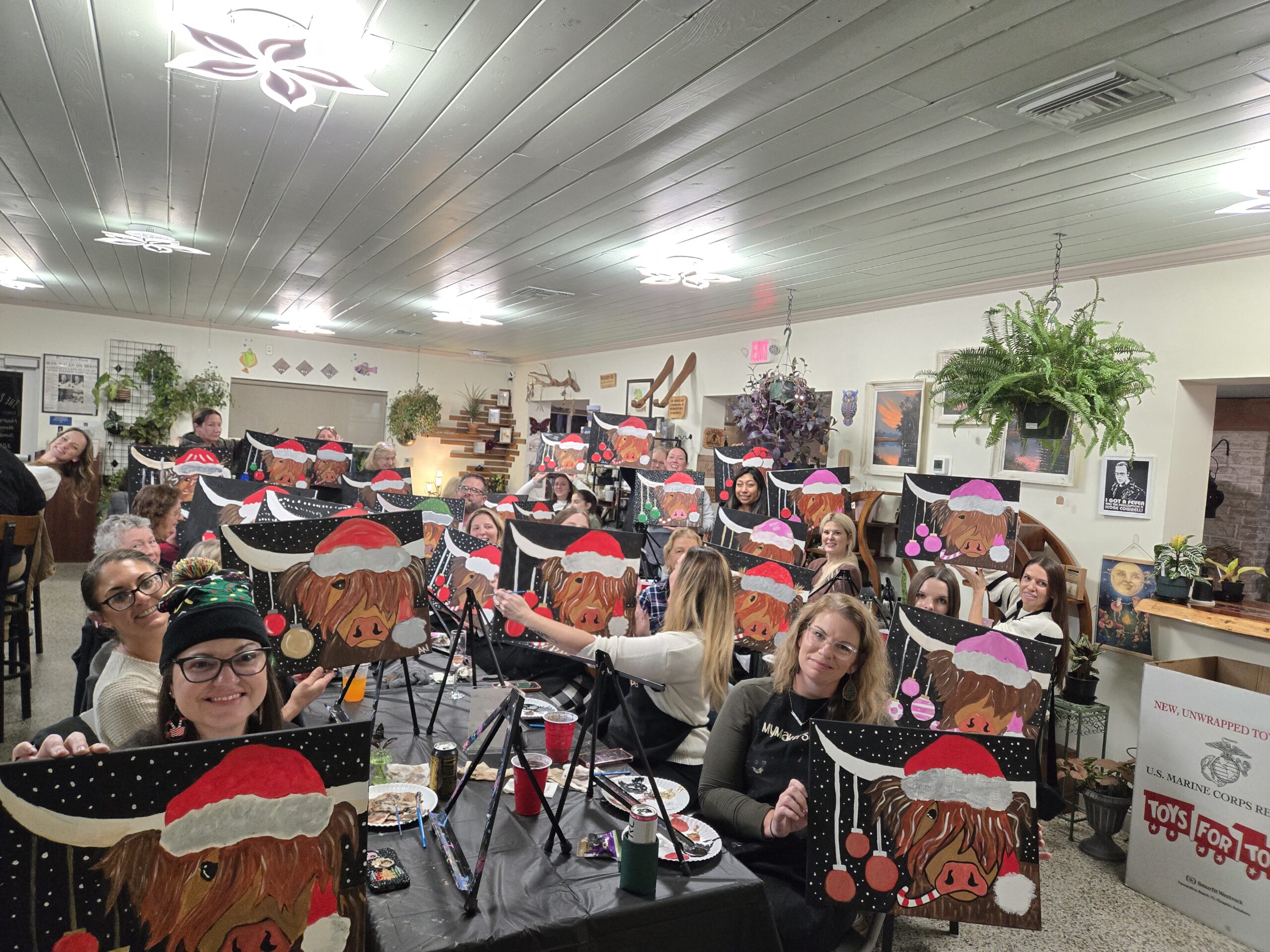 Guests painting at a MyMakerScape holiday paint night at The Plant Shack